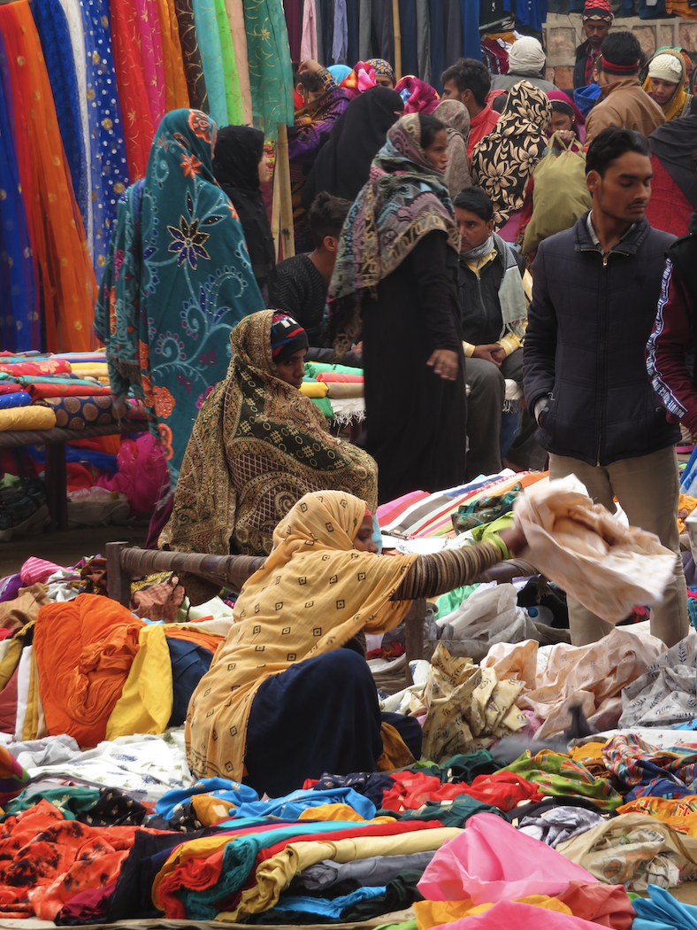 Outdoor market with women on the ground selling their products 2