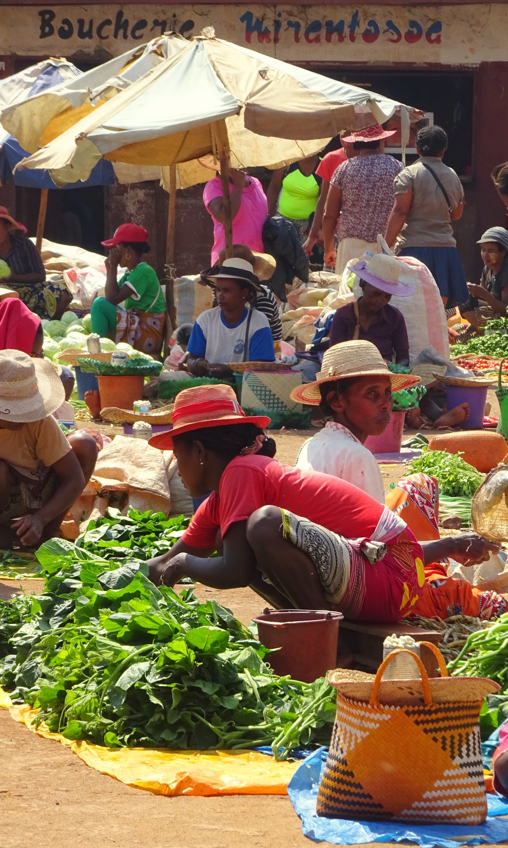 Outdoor market with women on the ground selling their products