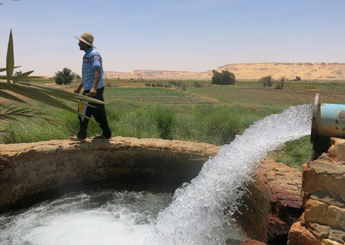 Water source surrounded by a landscape with a man