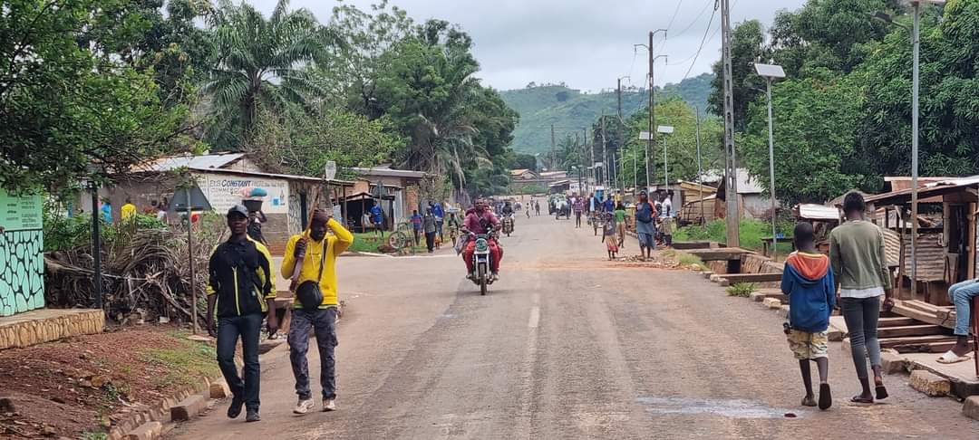 People and vehicles on the street in Cameroon