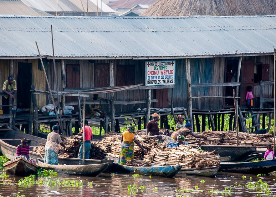 Women on the bank beside a small boat in Sô-Ava, Benin
